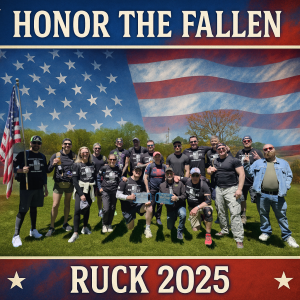 A group of people pose outdoors holding an American flag, wearing matching shirts that read “Honor the Fallen.” The background features a large American flag and the text “HONOR THE FALLEN RUCK 2025.”.